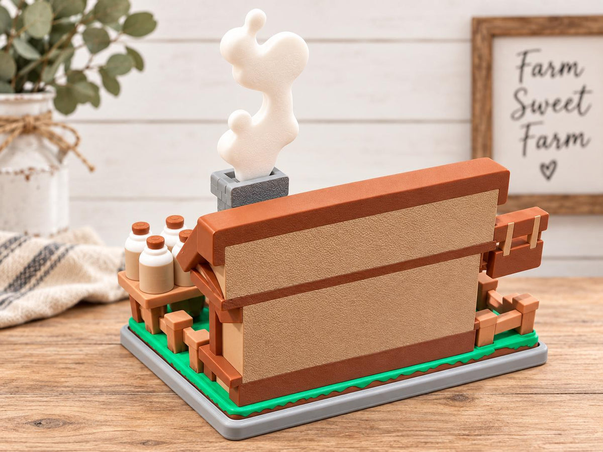 Rear view of the 3D printed farmhouse playset, showing a tan wall with brown trim, gray chimney with white smoke detail, fenced green base, and miniature milk bottles.